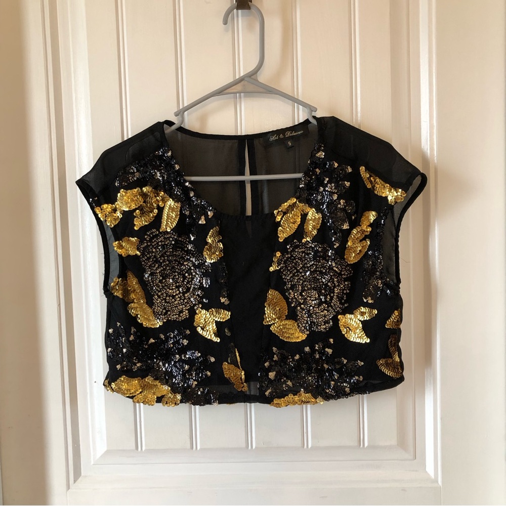 dance wear/top. Gold and black Sequined Great condition leotard top Size small